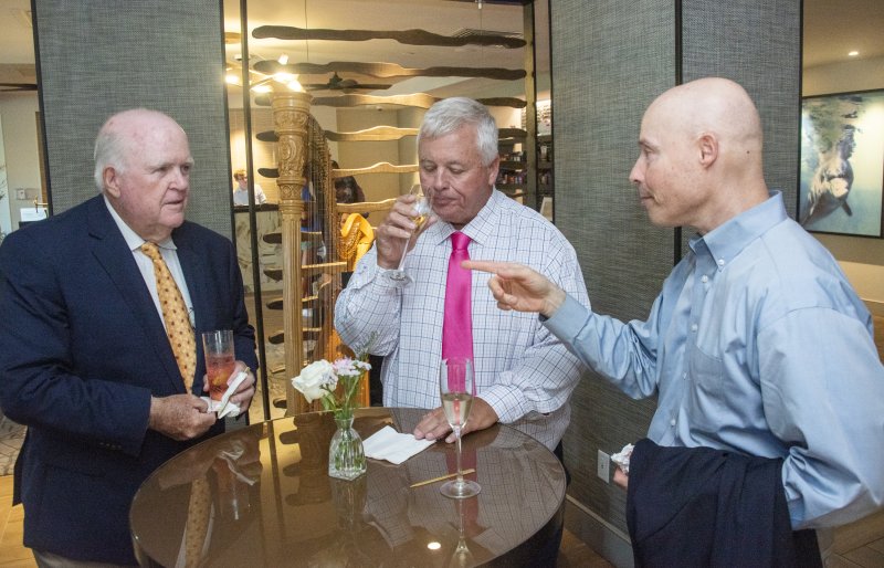 Event co-host Host Thom Harvey (l-r) chats with dinner guest Rob Burton and Alex Papajohn, Rehoboth Beach Historical Society director.